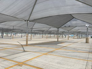 Row of gray shade structures in auto assembly plants.