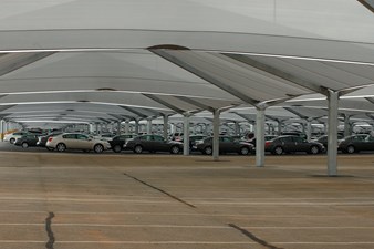 Cars under shade structures at auto assembly plant