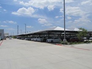 Cars at dealership under shade structures