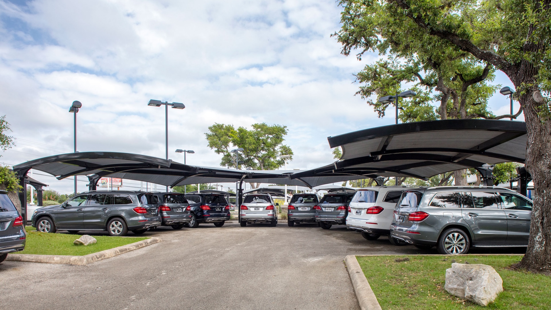 automobile dealership with shaded parking