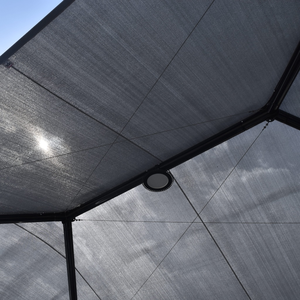the view looking skyward, protective shade structure with light fixture along the peak thumbnail