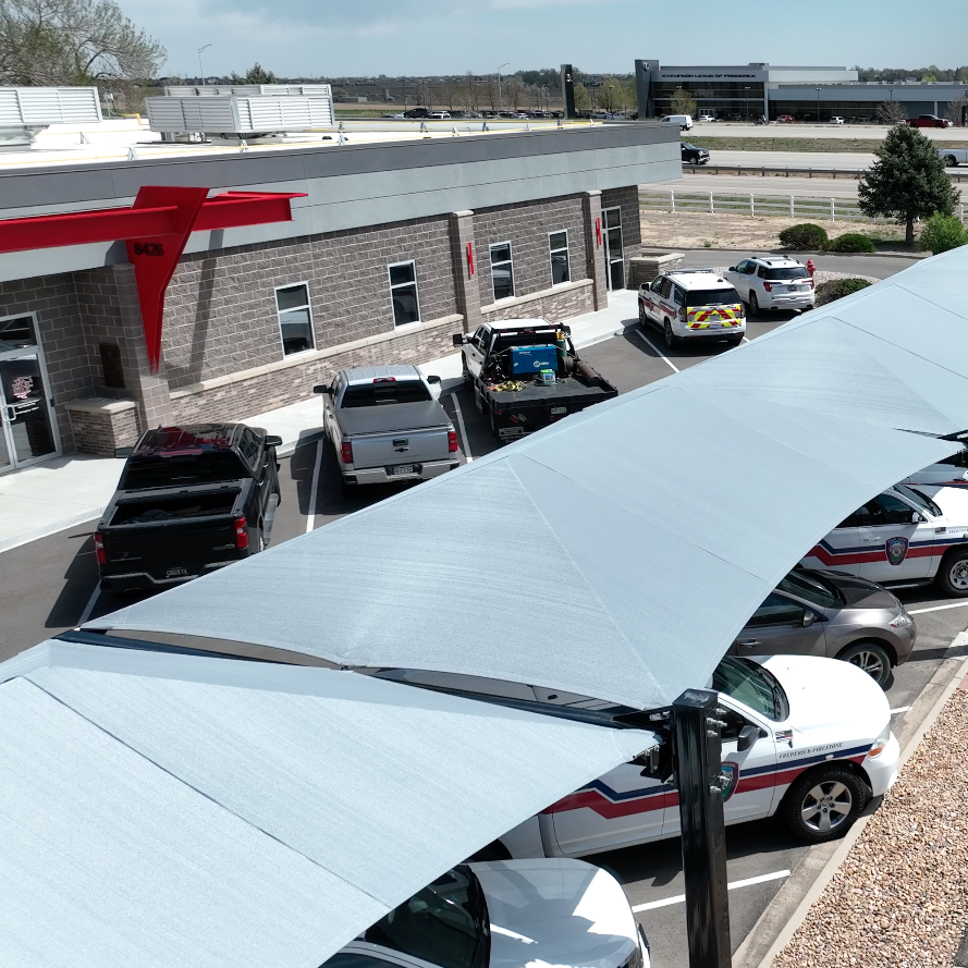the view from overhead, emergency vehicles covered by protective shade structure thumbnail