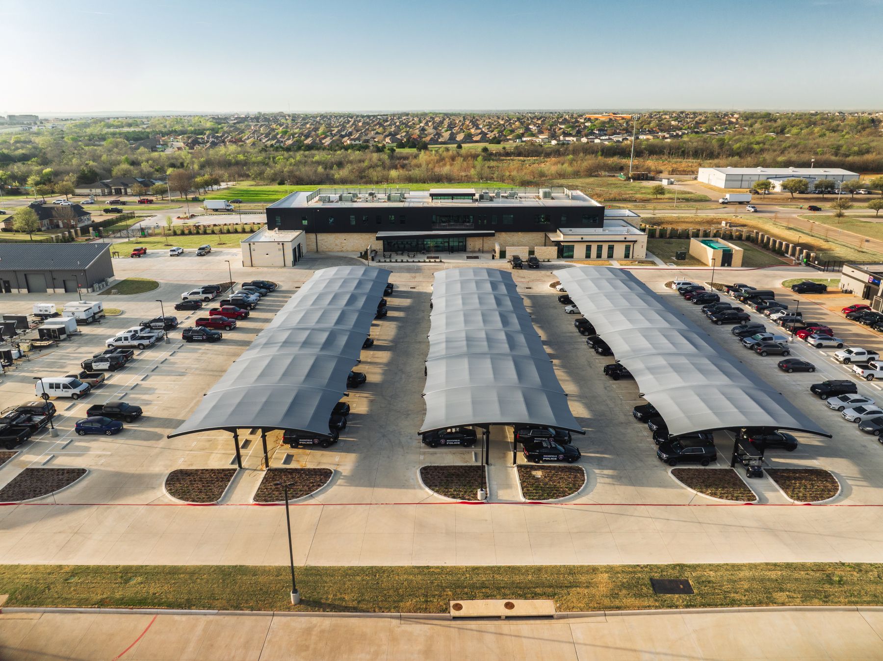 Mansfield Police Department, aerial view of parking area, vehicles protected from the elements